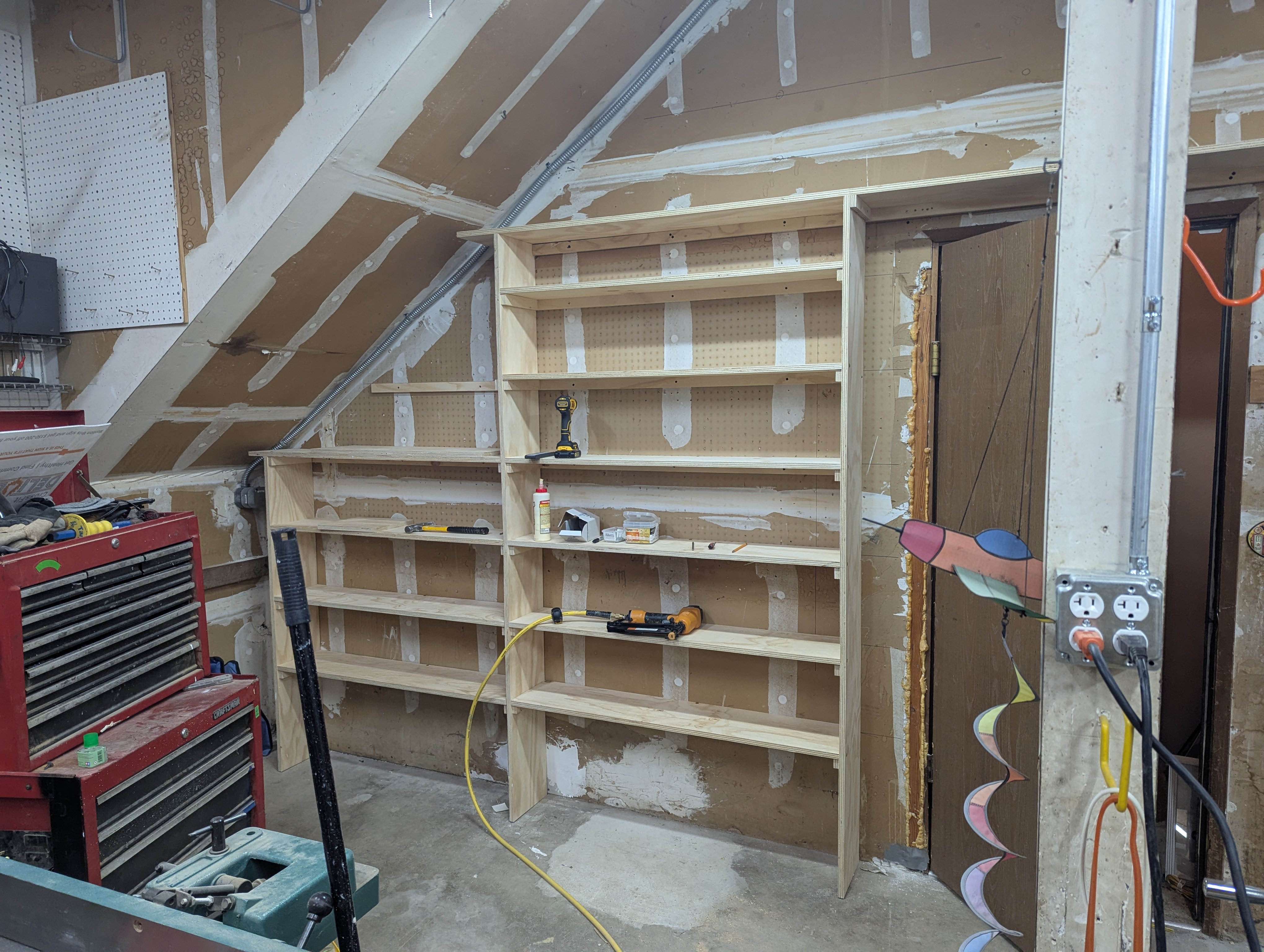 Built-in open shelving unit custom fitted under an angled roofline